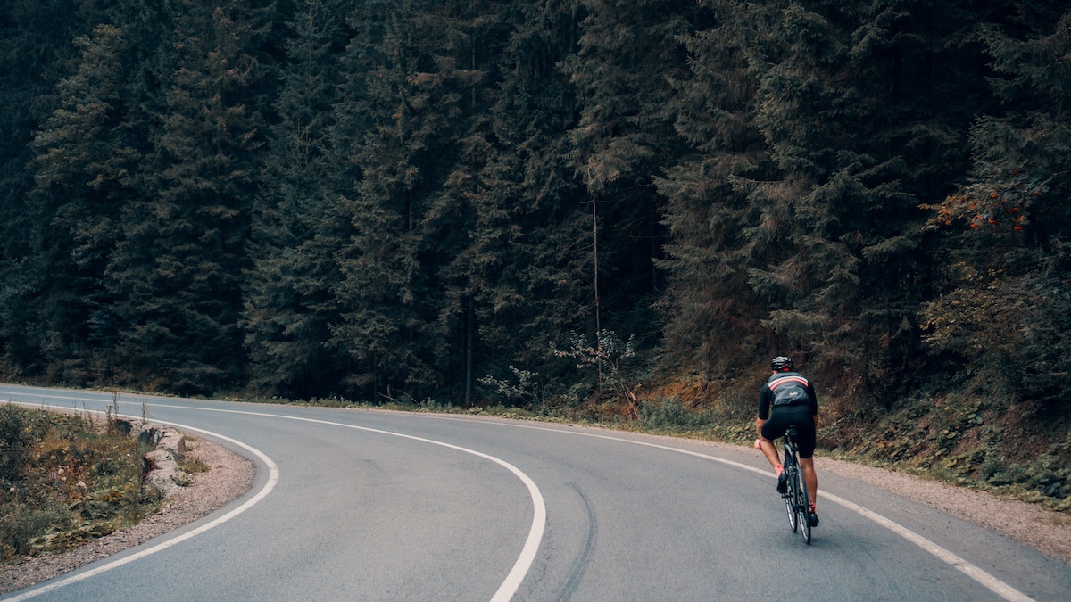 man biking along the open road