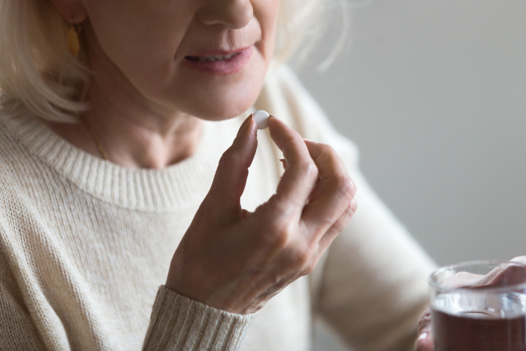 Elderly woman taking medication