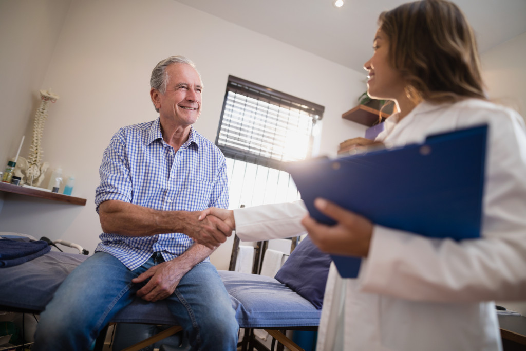 A senior man shaking hands with a doctor