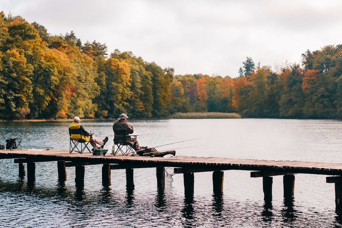 two men fishing on lake