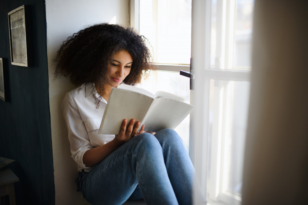 woman with a notebook by the window