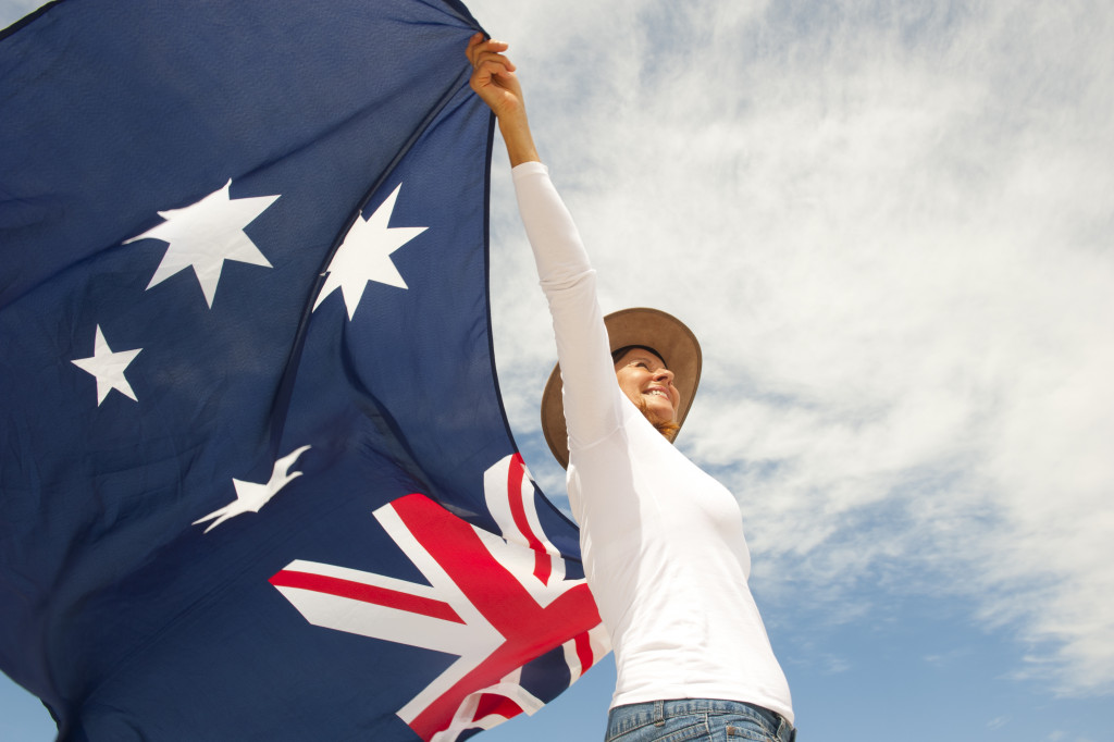 woman carrying australian flag with sky as background