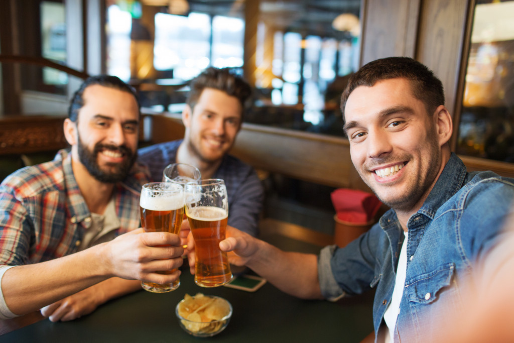 Group of friends drinking beer at a bar.