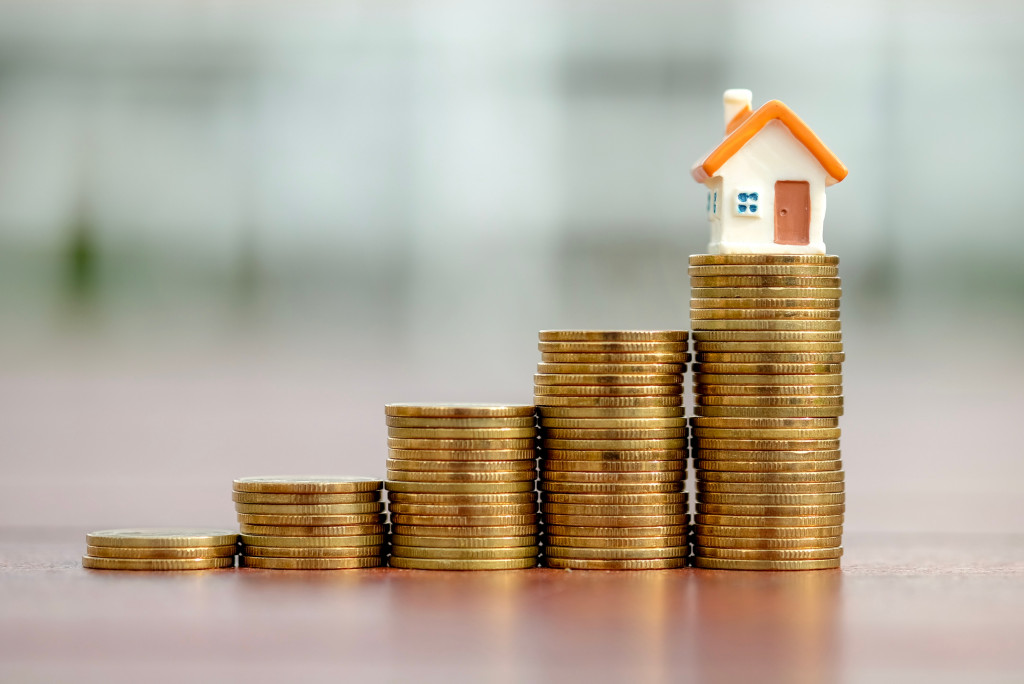 Houses stacking on top of coins