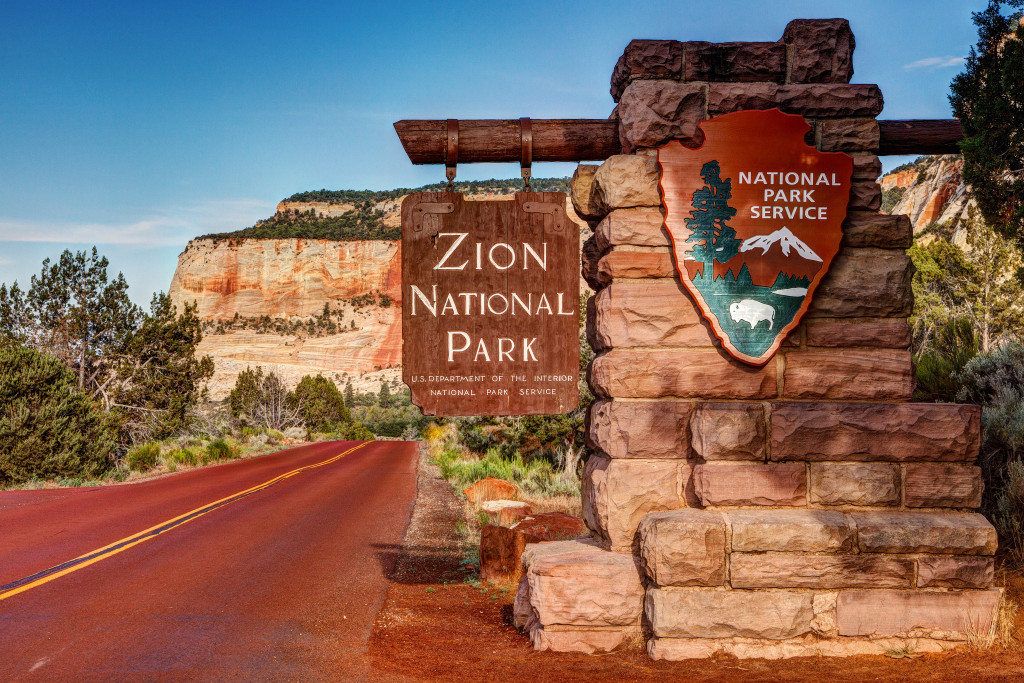 entrance to zion national park with signs