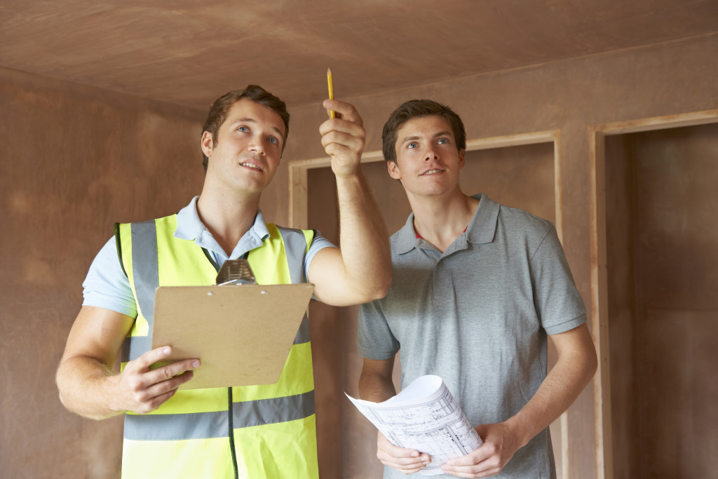 Two handsome men looking at a new home property