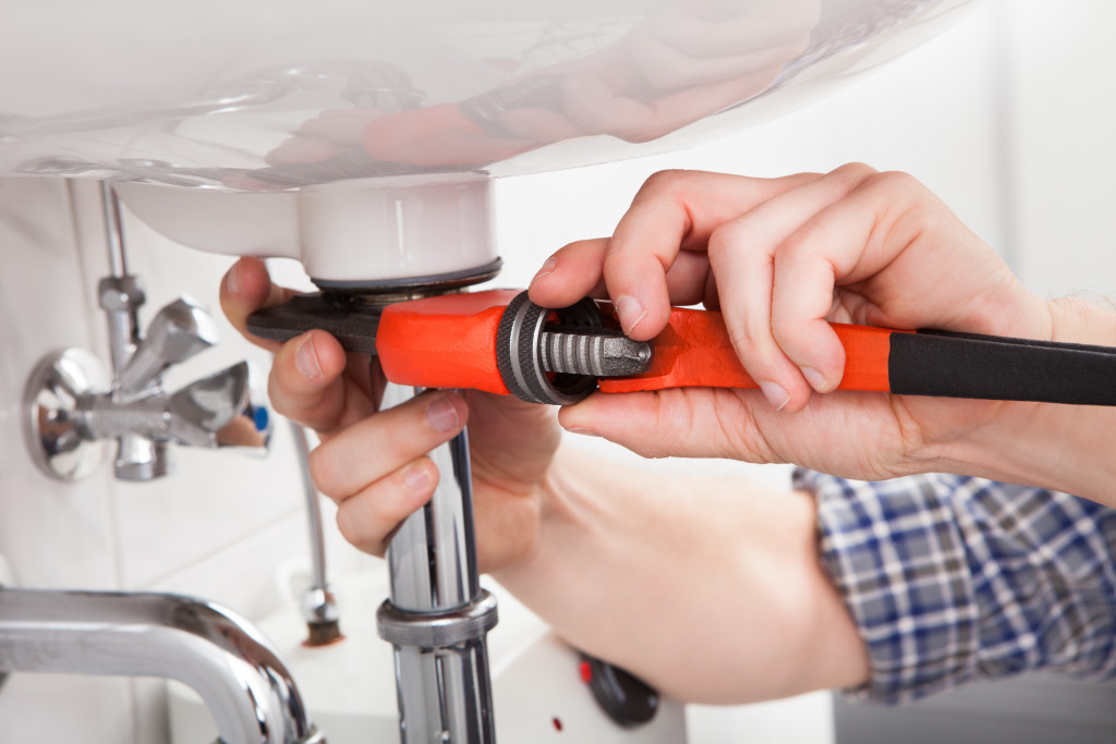 A plumber fixing a bathroom sink