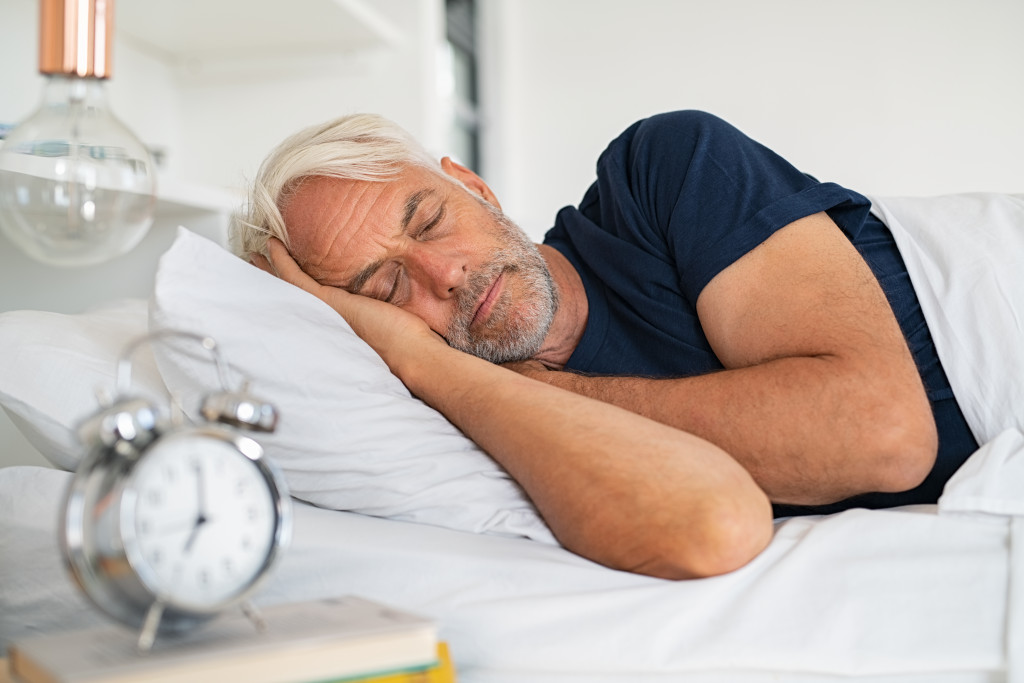 Senior man with white hair in deep sleep