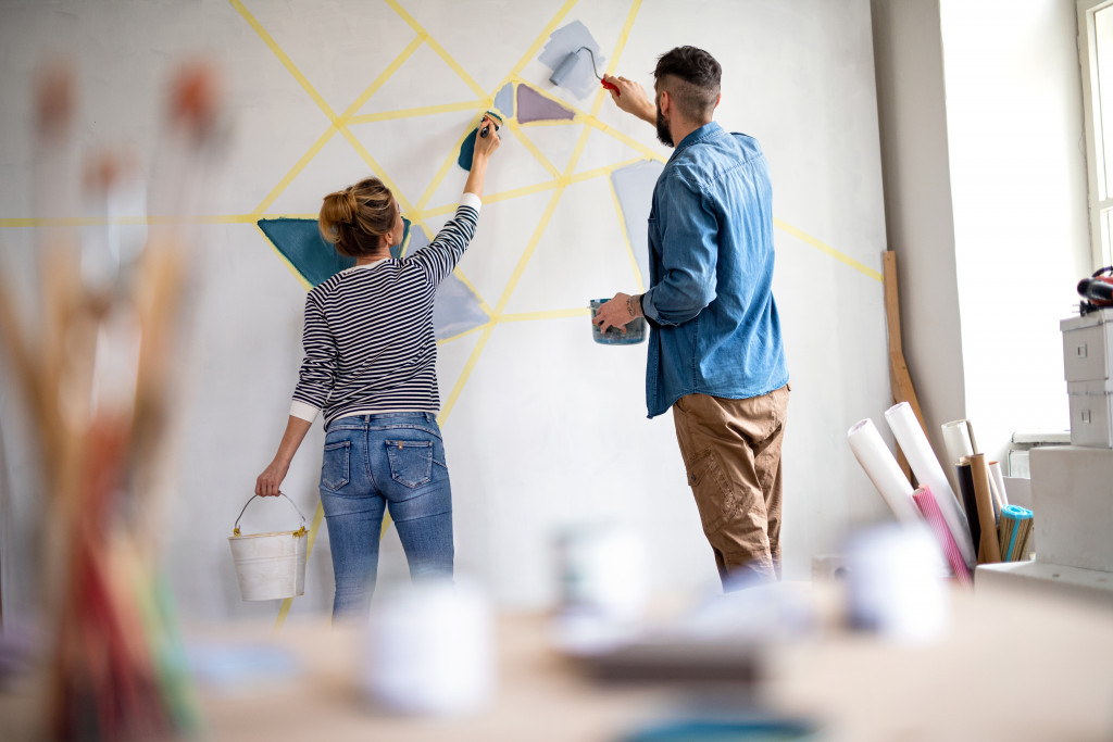 couple DIY paint on their wall