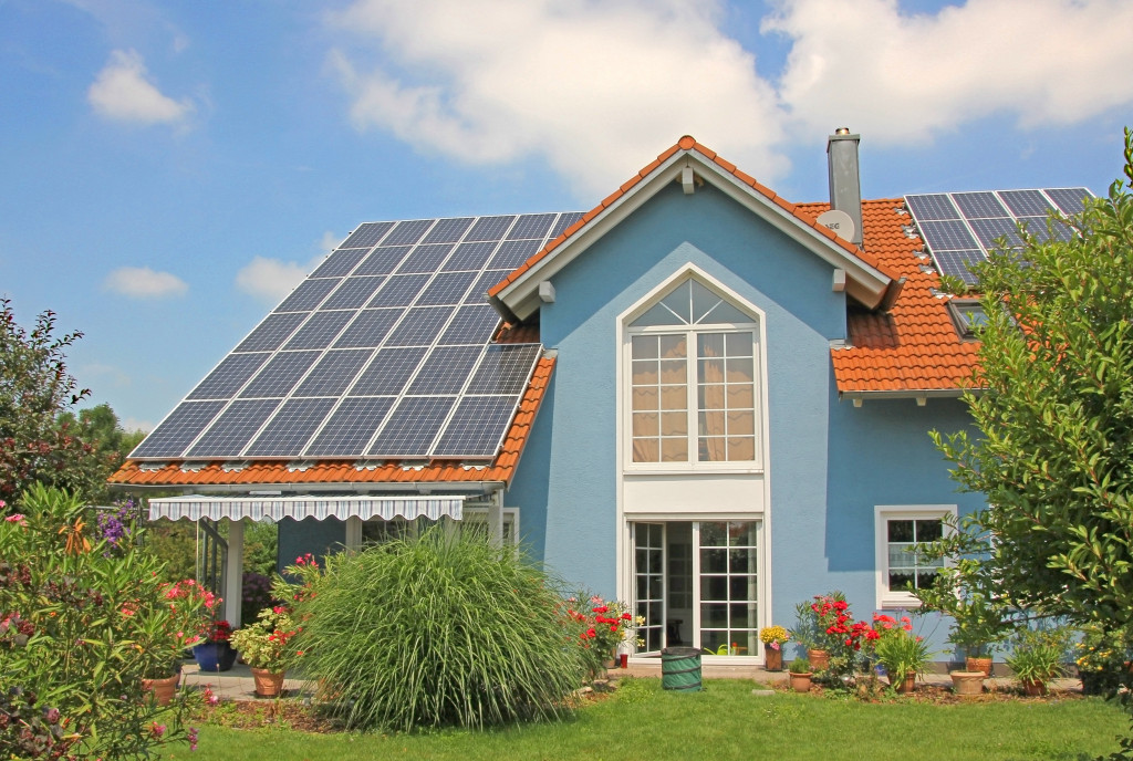 rooftop with solar cells, blue front with lattice window.