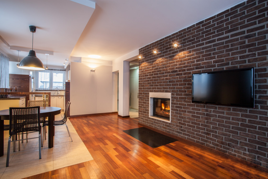 modern home with fireplace and brick wall