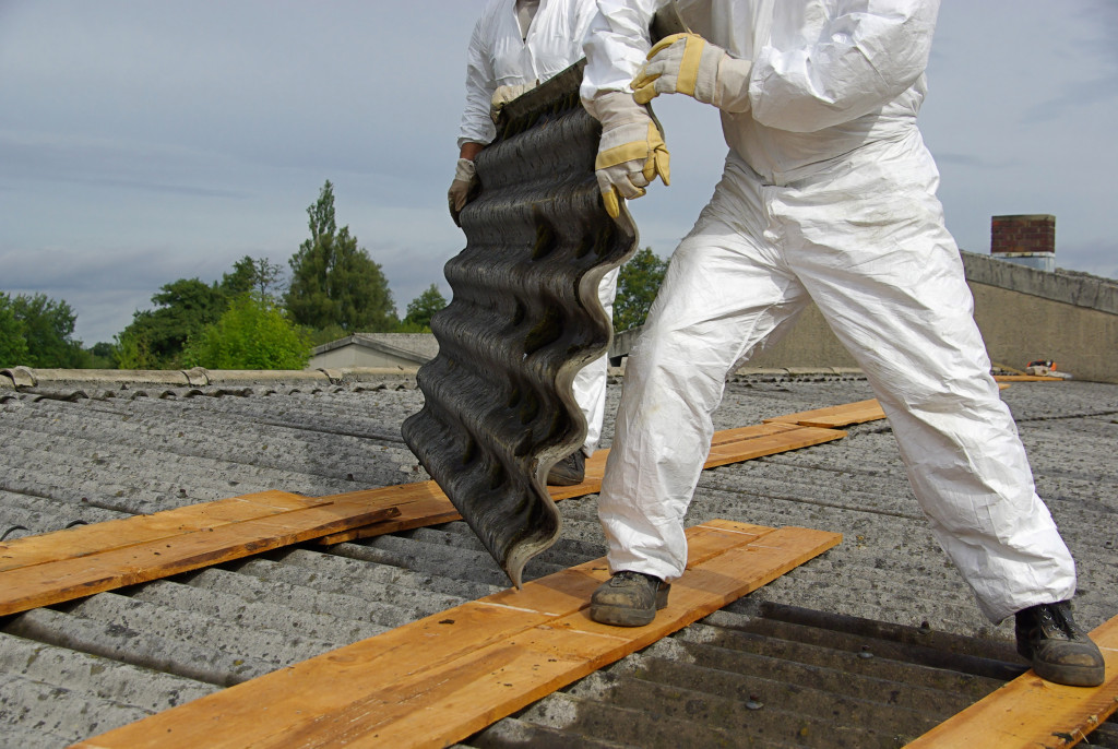 workers on the roof with metal material